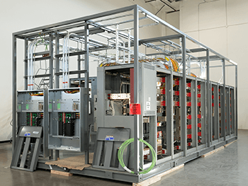 Modular industrial control system with electrical panels, wiring, and steel framework